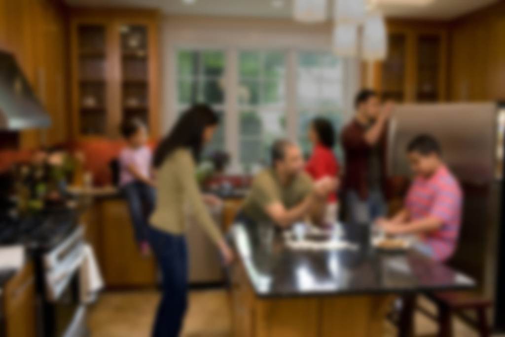 family talking in kitchen