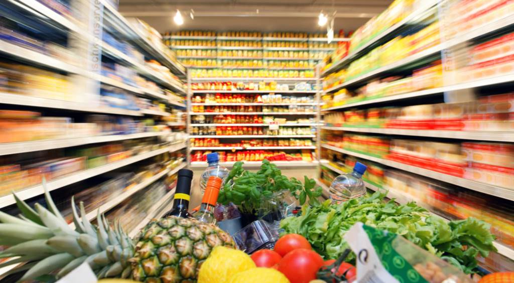 full grocery cart in a store aisle