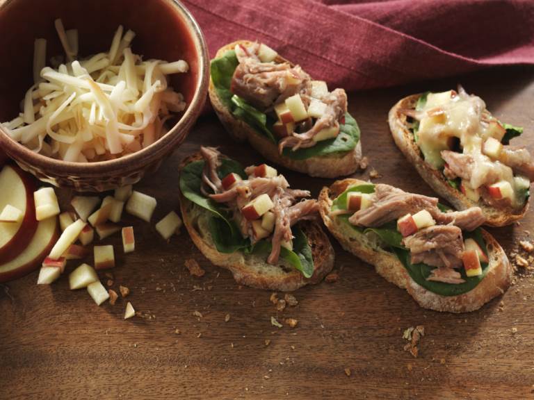 4 Cherry Balsamic Pork Crostinis on a cutting board